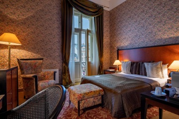 Superior Room front view with beige wallpaper at the Grandhotel Pupp